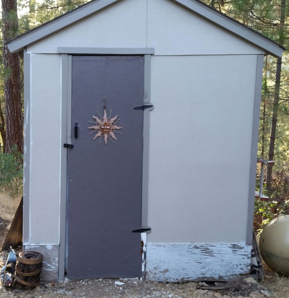 Rotted wood on shed before adding corrugated metal, trim, and paint